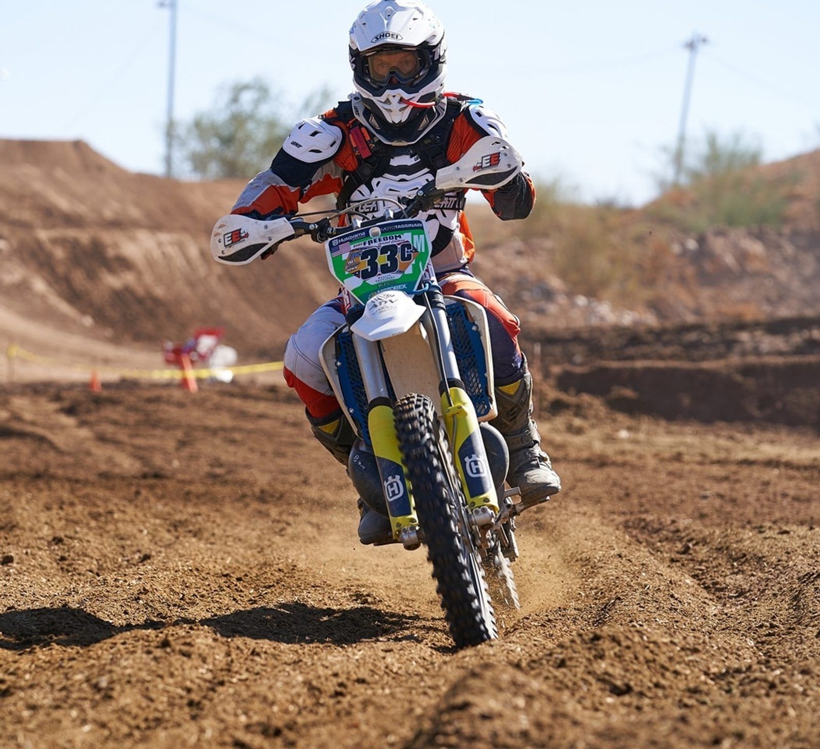 Motocross supplements: motocross rider on a Husqvarna in a dirt berm turn