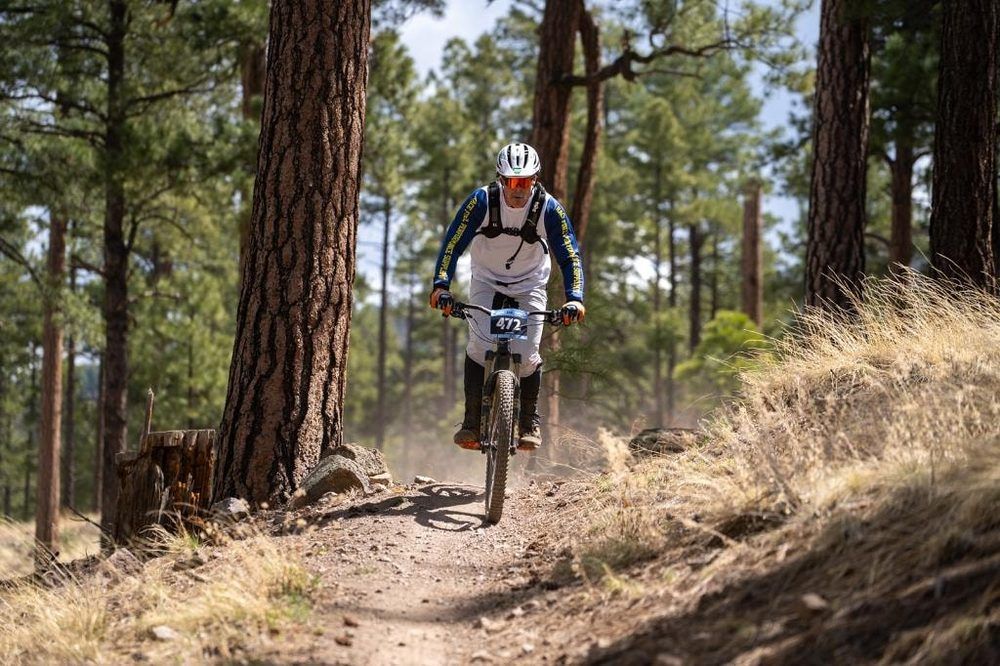Personal Training from a motocross supplements: mountain bike racer in a Race Fuel jersey riding a pine forest trail